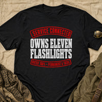 Load image into Gallery viewer, Service Connected Owns Eleven Flashlights - Funny Veteran Tee in Black, props flat